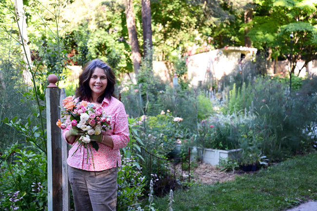 Gloria B. Collins in her Hudson Valley cottage style garden holding freshly cut roses