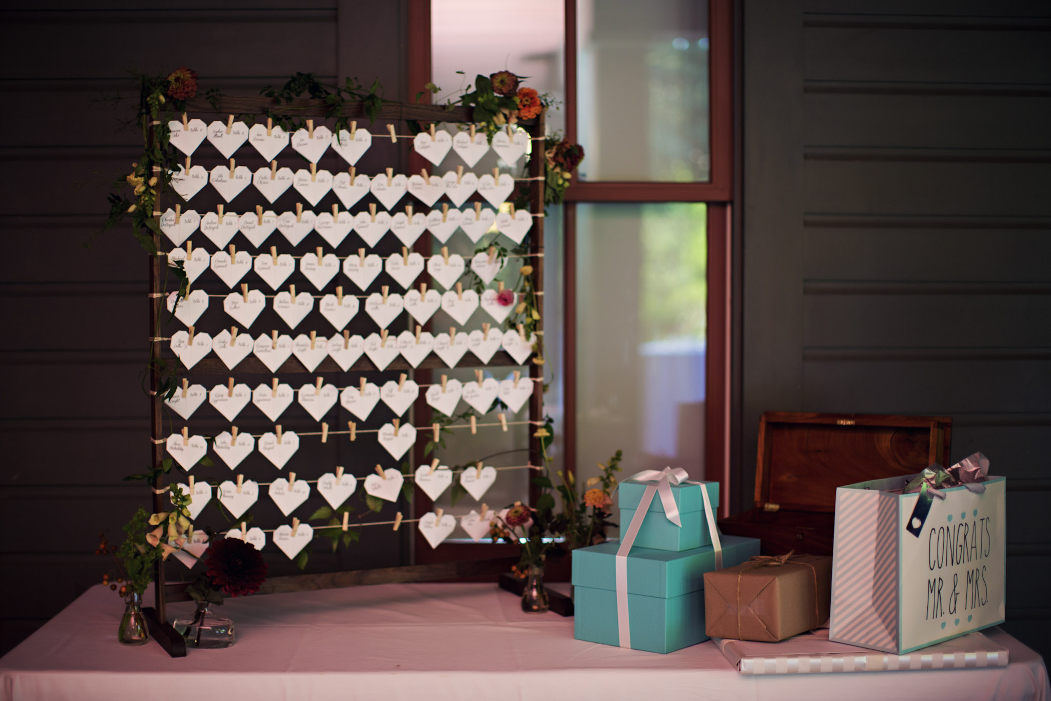 Photo by Elizabeth Fox of handmade wooden clothesline display for heart shaped seating cards